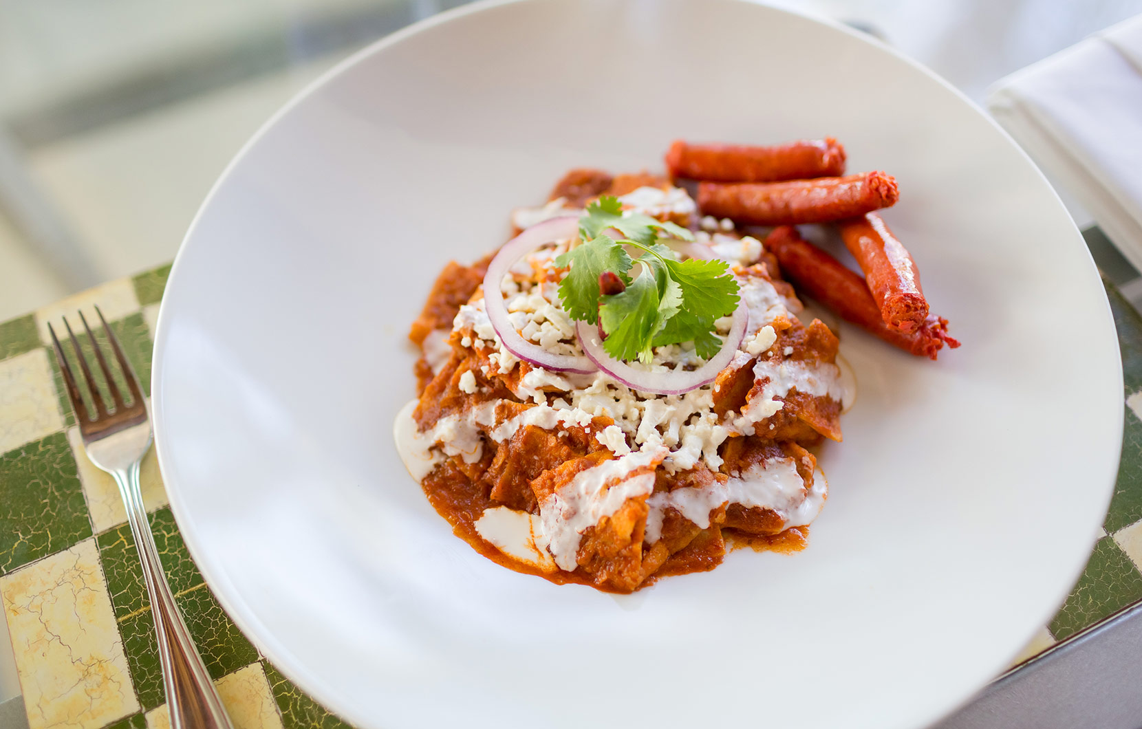 Red chilaquiles and spicy Merguez sausage.