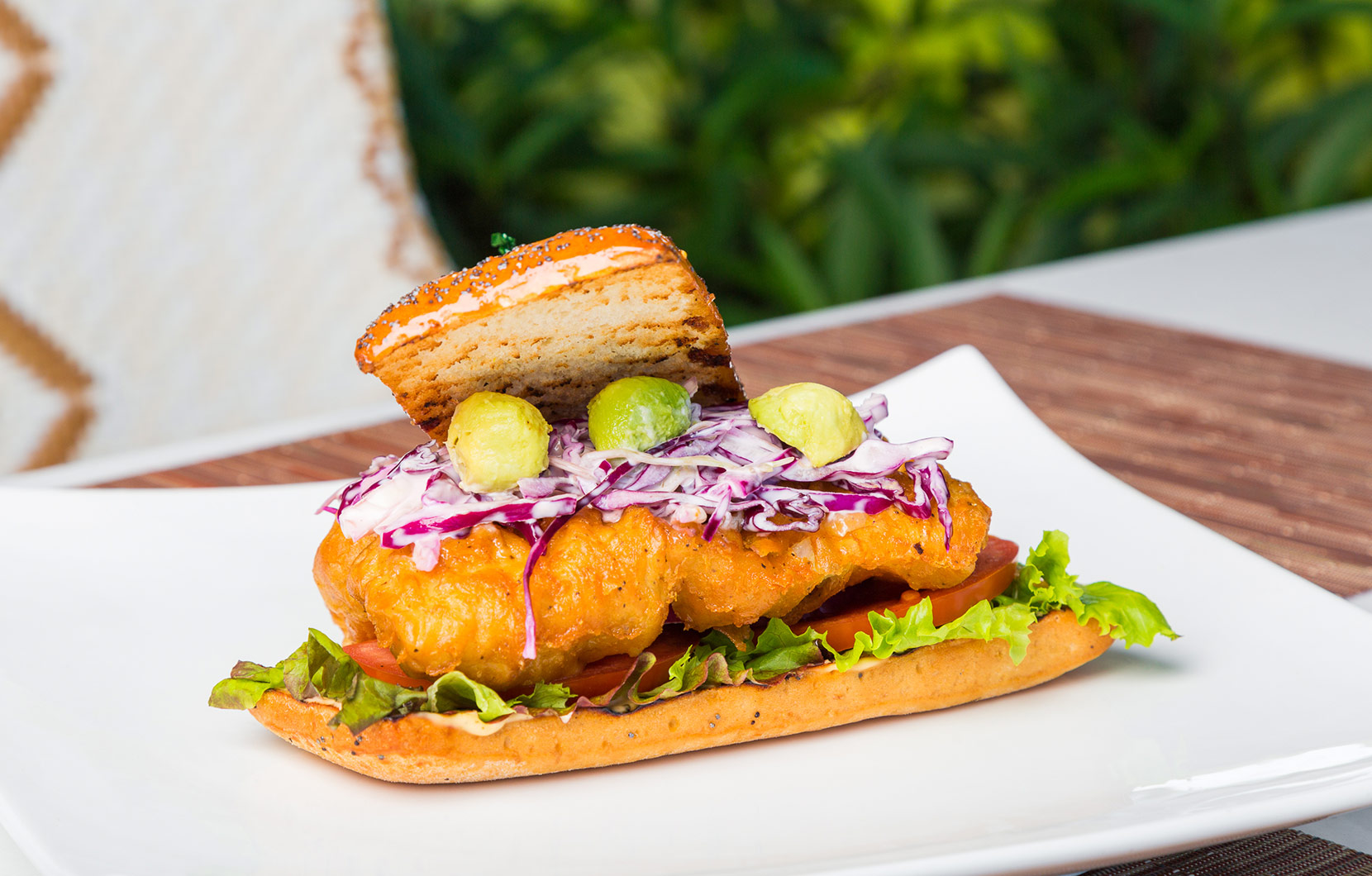 A flaky fish fillet topped with avocado pearls gives Chef Felipe’s burger its character.