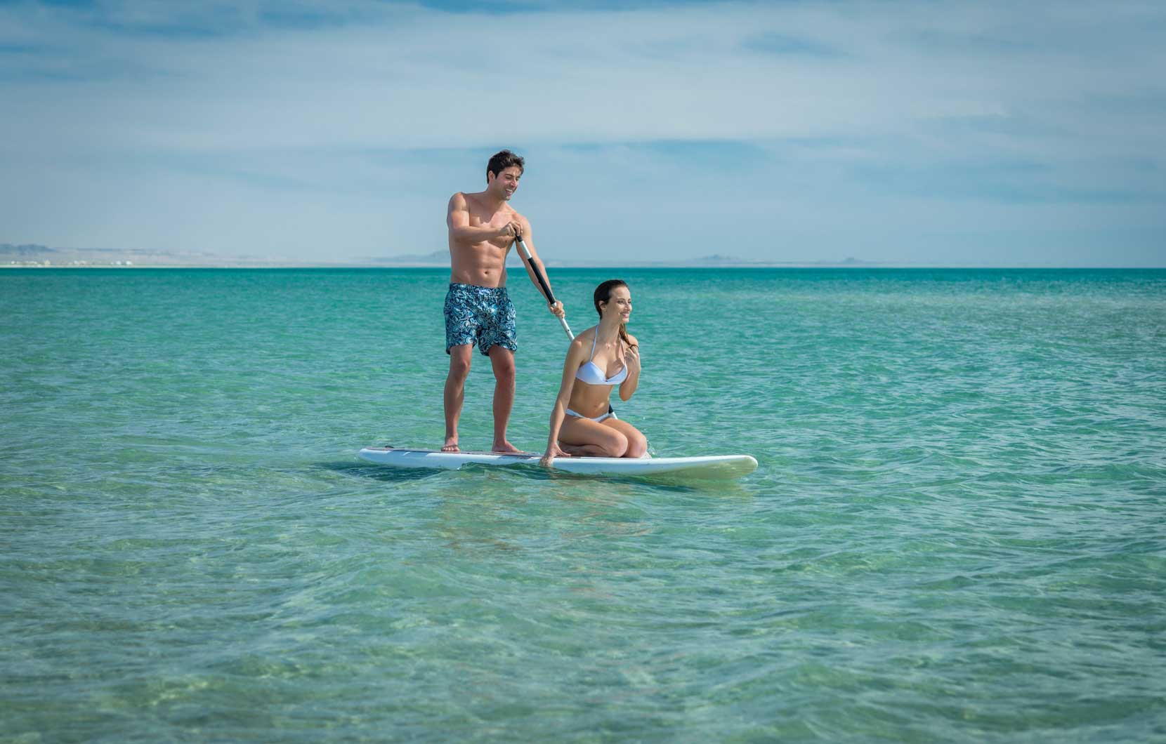 Stand-up paddle boarding is a unique way to workout while on vacation.